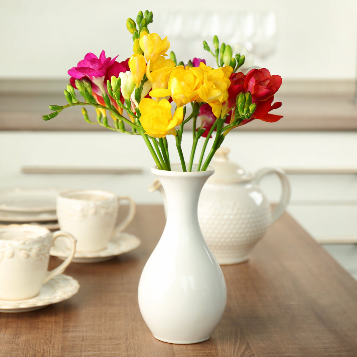 Yellow, Orange and Pink Freesia Flowers in Vase